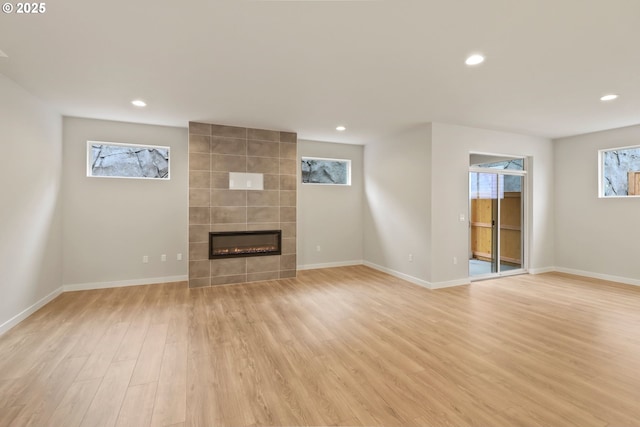 unfurnished living room featuring a fireplace and light wood-type flooring