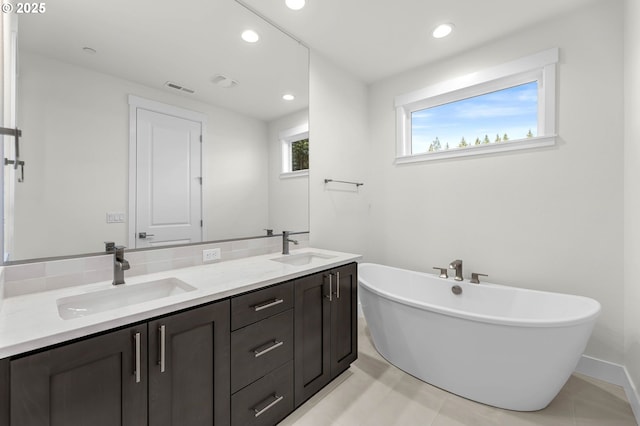 5591 N 93rd Ave Unit Lt206, Camas, WA 98607 - bathroom featuring a freestanding tub, double vanity, a sink, and visible vents