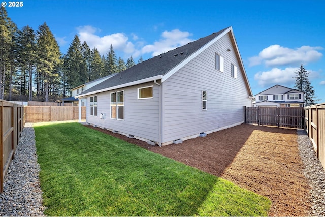 5591 N 93rd Ave Unit Lt206, Camas, WA 98607 - rear view of house featuring roof with shingles, a fenced backyard, and a lawn