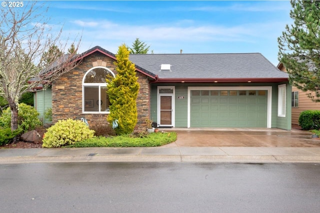 view of front of home featuring a garage, stone siding, and driveway