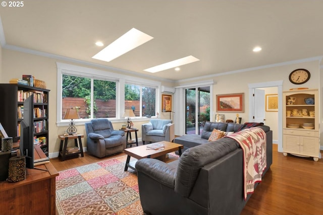 living area with wood finished floors, baseboards, a wall mounted AC, a skylight, and ornamental molding