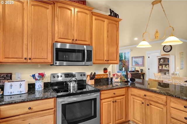 kitchen with dark stone countertops, decorative light fixtures, and appliances with stainless steel finishes