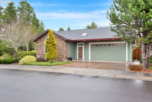 ranch-style home featuring a garage, stone siding, a shingled roof, and fence