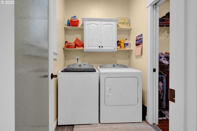 laundry room featuring cabinet space and washing machine and clothes dryer