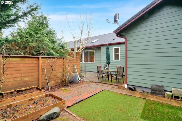 view of yard with a patio area, a vegetable garden, and fence