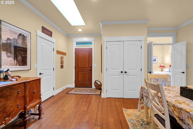 entrance foyer with recessed lighting, baseboards, light wood-style flooring, and crown molding