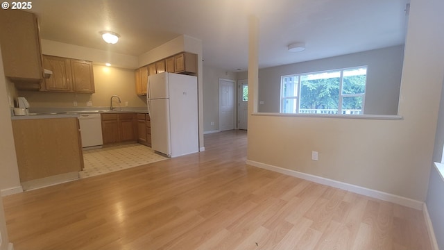 3730 N Albina Ave, Portland, OR 97227 - kitchen with white appliances, light wood-style floors, a sink, light countertops, and baseboards