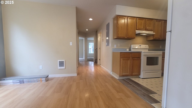 kitchen featuring visible vents, white appliances, recessed lighting, under cabinet range hood, and light wood finished floors