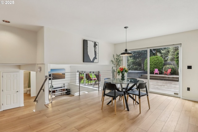 dining room featuring baseboards and light wood finished floors