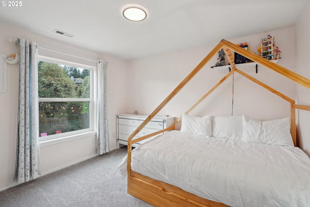 carpeted bedroom featuring visible vents and baseboards