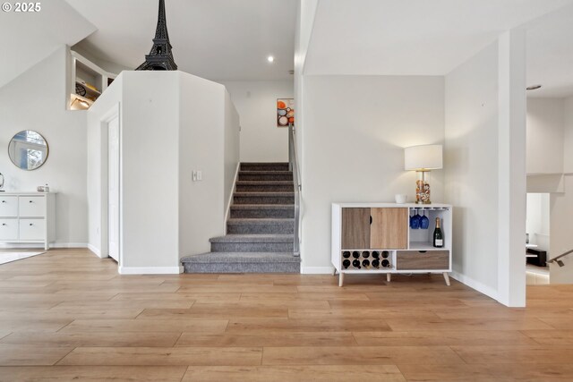 stairs featuring hardwood / wood-style floors