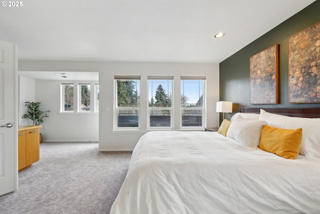 bedroom featuring baseboards, recessed lighting, and light carpet