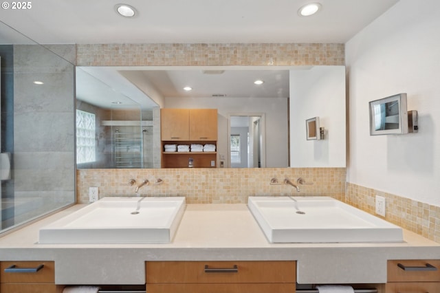 bathroom featuring walk in shower, vanity, and decorative backsplash