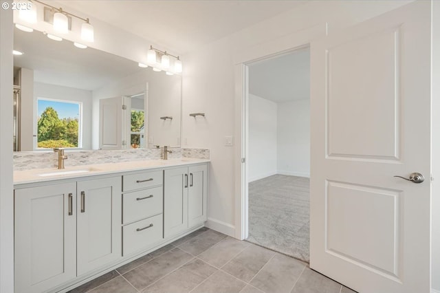 bathroom featuring vanity and tasteful backsplash