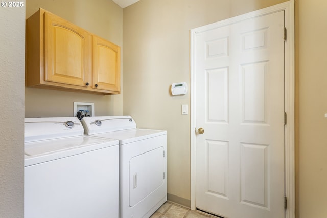 washroom with cabinet space, independent washer and dryer, baseboards, and light tile patterned floors