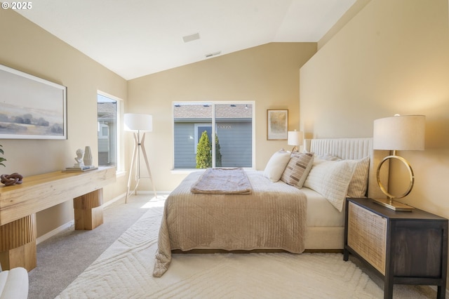 bedroom with lofted ceiling, visible vents, baseboards, and carpet flooring