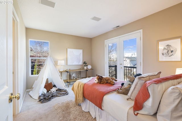 carpeted bedroom featuring access to exterior, french doors, visible vents, and multiple windows