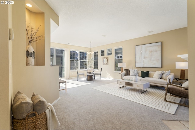 living area featuring carpet floors and a textured ceiling