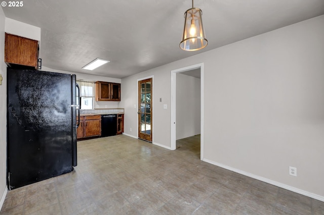 5430 E St, Springfield, OR 97478 - kitchen with black appliances, light countertops, pendant lighting, light flooring, and brown cabinets