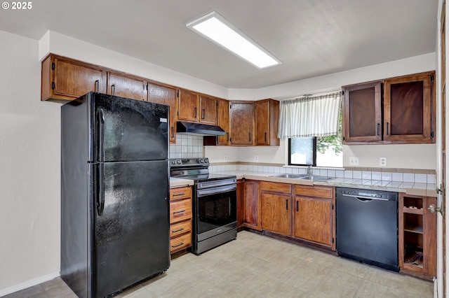 5430 E St, Springfield, OR 97478 - kitchen with black appliances, under cabinet range hood, and brown cabinets