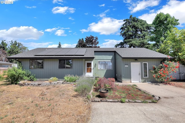 5430 E St, Springfield, OR 97478 - view of front facade with roof mounted solar panels and a shingled roof