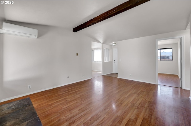 5430 E St, Springfield, OR 97478 - unfurnished living room featuring healthy amount of natural light, a wall mounted air conditioner, and wood finished floors