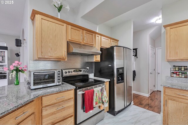 3963 NW 148th Pl, Portland, OR 97229 - kitchen with under cabinet range hood, appliances with stainless steel finishes, light brown cabinets, backsplash, and light stone countertops