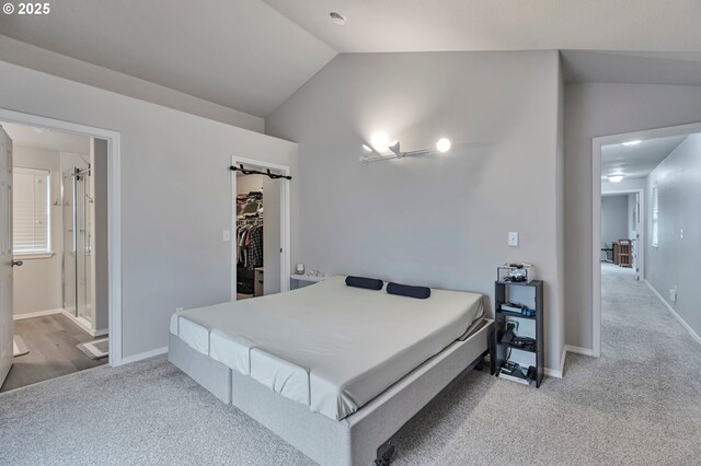 3963 NW 148th Pl, Portland, OR 97229 - bedroom with lofted ceiling, carpet floors, a walk in closet, ensuite bath, and baseboards