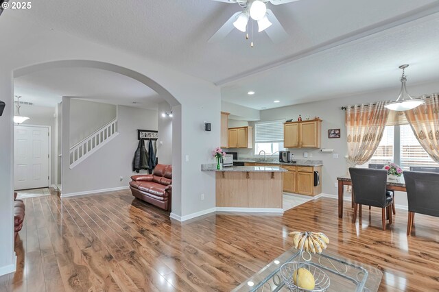 3963 NW 148th Pl, Portland, OR 97229 - living room featuring arched walkways, ceiling fan, light wood-type flooring, recessed lighting, and baseboards