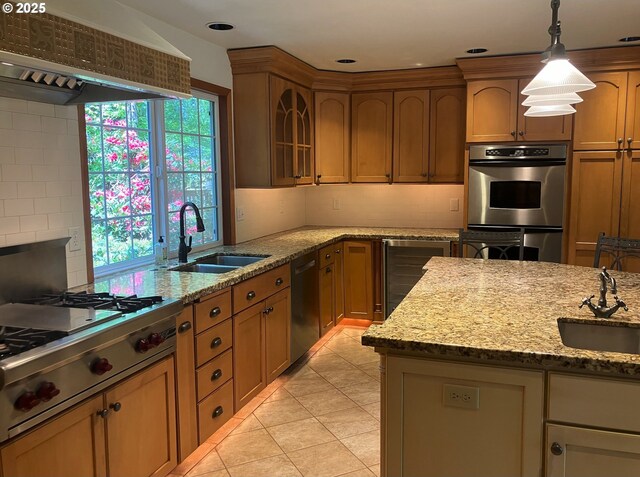 1950 NW 107th Ave, Portland, OR 97229 - kitchen featuring stainless steel gas stovetop, extractor fan, a sink, and decorative backsplash
