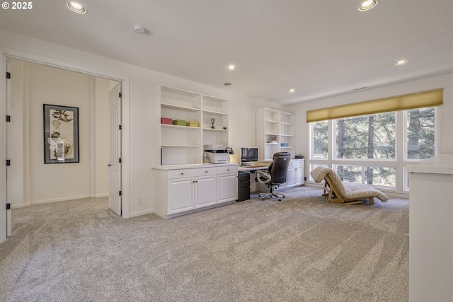 office with baseboards, recessed lighting, built in features, and light colored carpet