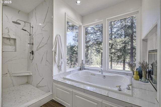 full bathroom featuring recessed lighting, a marble finish shower, and a bath