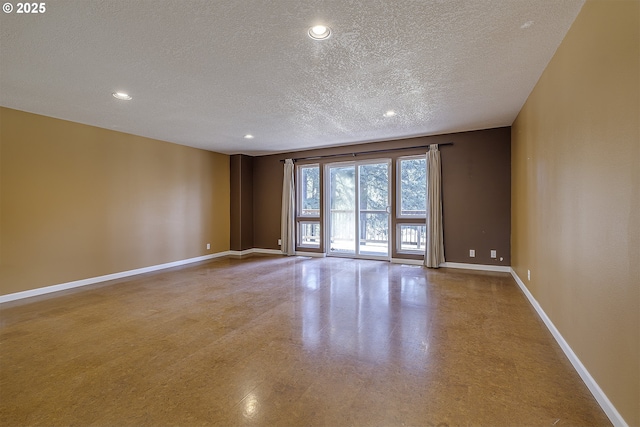 unfurnished room featuring baseboards, a textured ceiling, and recessed lighting