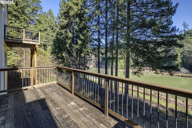 wooden terrace featuring a water view