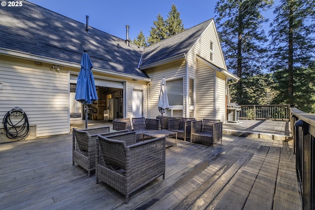 deck with outdoor lounge area and area for grilling