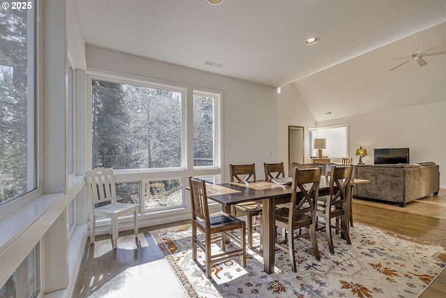 dining space with visible vents, a wealth of natural light, and wood finished floors