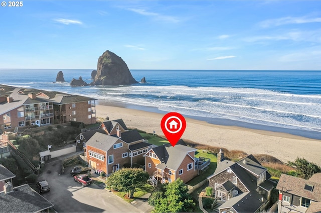 bird's eye view with a water view and a beach view