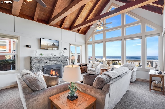 living room with a wealth of natural light, wood ceiling, and ceiling fan