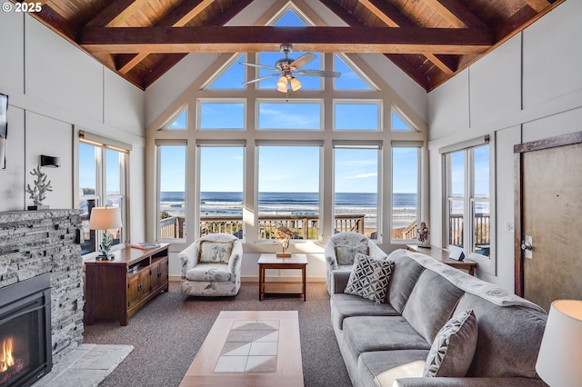 sunroom with a water view, wood ceiling, a healthy amount of sunlight, and a fireplace