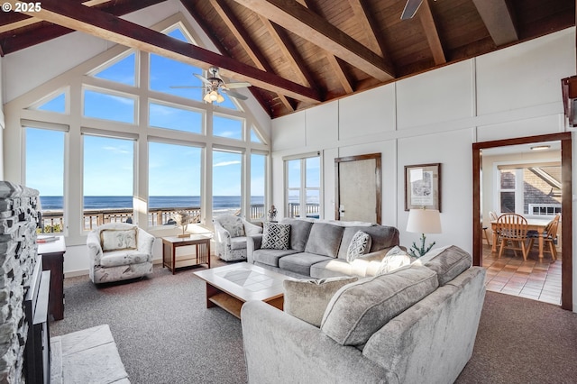 living room featuring wood ceiling, ceiling fan, a water view, carpet floors, and lofted ceiling with beams