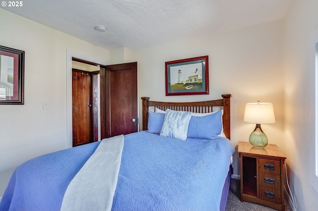 carpeted bedroom with a textured ceiling