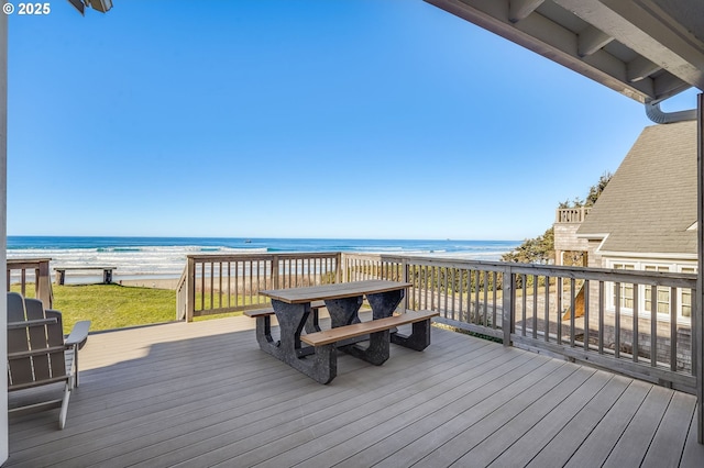 wooden terrace with a view of the beach and a water view