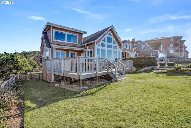 back of property featuring a wooden deck and a lawn