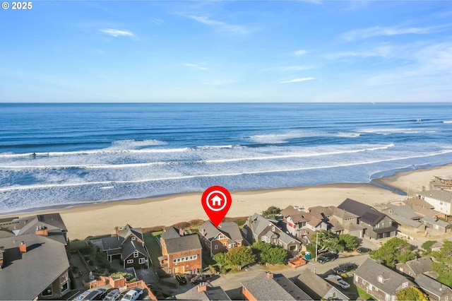 birds eye view of property with a beach view and a water view