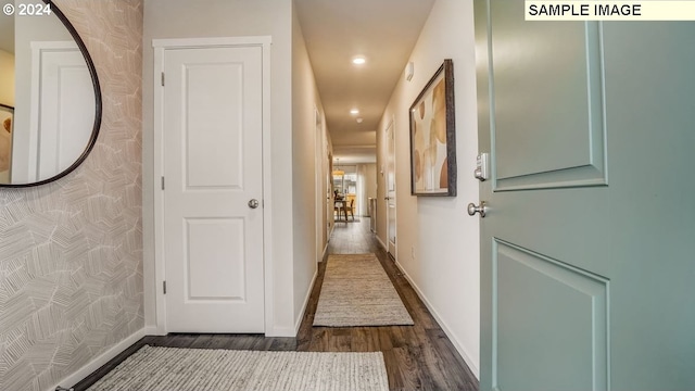 hallway with baseboards, dark wood-type flooring, and recessed lighting