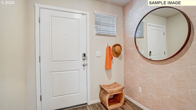 interior space featuring baseboards and wood finished floors