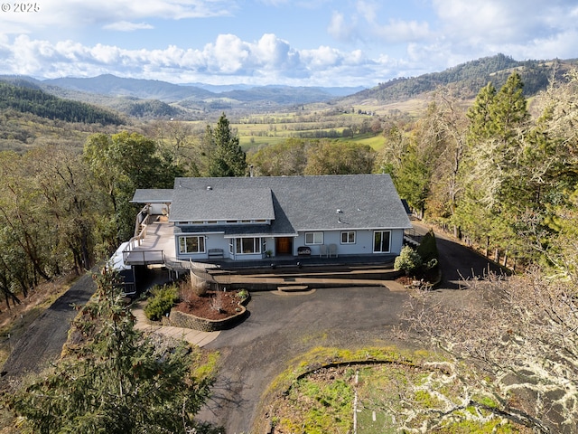 exterior space with a deck with mountain view