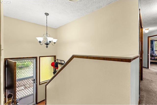 835 E 4th St, La Center, WA 98629 - entrance foyer featuring a textured ceiling, light carpet, and a chandelier