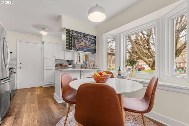 dining area featuring a healthy amount of sunlight and wood finished floors