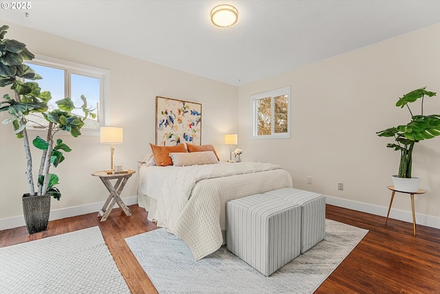 bedroom with baseboards and wood finished floors